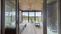 Doors open to the screened-in porch to extend and combine the entertainment areas