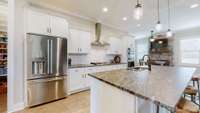 Leathered Granite counters throughout.  All kitchen top-of-the-line Cafe' Stainless appliances stay.