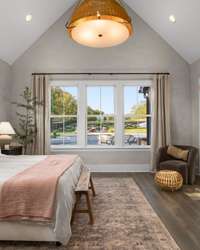 The primary bedroom features a unique and gorgeous Lime Wash detail on the walls.