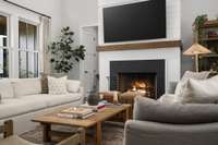 Living room features a wood-burning fireplace equipped with a gas starter.