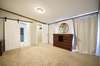 Master bedroom with sliding barn door and large walk in closet