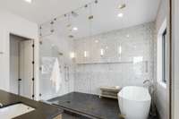 Fully enclosed frameless glass wet room in the primary bath is spectacular!