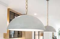 Kitchen island pendants are an excellent match to the custom stucco on the range hood