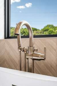 Brushed gold faucets throughout the primary bath