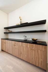 Additional cabinetry flanks both sides of the fireplace, excellent for additional storage, art, display or bar items