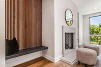 The stucco fireplace, limestone, surround and acoustic panels bring warmth to this modern design