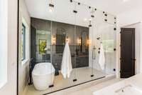 Fully enclosed frameless glass goes all the way to the ceiling creating a spa-like and zen space to relax and unwind