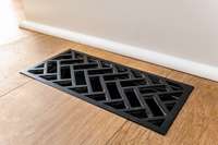 Black iron grates add style and sophistication to the wide plank hardwoods in this home