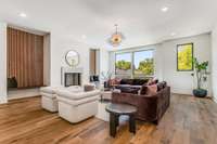 Another view of the living room showing the textured velvet paint fireplace, built-in benches and floor-to-ceiling windows.