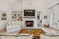 Comfy living space featuring a gas fireplace and built-in bookshelves