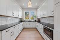 you will love the prep/caterer's kitchen with expansive counter space tucked behind the kitchen