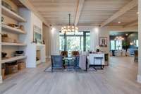 a spectacular view as you step into the living room: white oak planked ceilings + wood beams add an inviting warmth. the oversized sliding door lead onto a covered porch ready for the last of summer days or fall football saturdays.