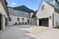 The arrangement of the garages creates a courtyard-like feeling on the side of the house.