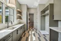 Laundry is a breeze in this spacious and thoughtfully designed laundry room.