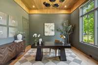 This dazzling home office features white oak ceiling detail and a beautiful view of the front lawn.