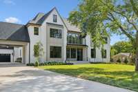 Situated on a flat, one-acre lot in the Meadowlake subdivision, this beautiful home features a large stone porch and striking black windows.