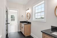 Stunning primary bath with double vanities, tub/shower combo, and linen closet!