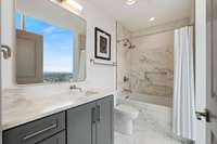 2nd bath on the glass with marble counters, and shower/tub combo.