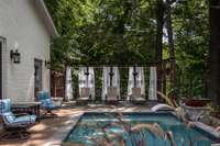 The pool area invites endless summer days of fun. With sauna jets and heated water, picture yourself floating in this serene oasis, with friends and family gathered poolside. Ample seating and nature's covering make this a delicious retreat.