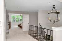 This bright, open hallway leads to the second-floor bedrooms and bonus room. Envision it as a space that ties the home together, connecting each part of this elegant retreat seamlessly.