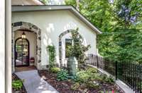 A grand, custom-designed entrance welcomes you home with its traditional Spanish flair and inviting warmth. Imagine stepping through these doors and into your own tranquil sanctuary, where modern living meets timeless elegance.