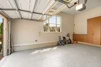 This over-sized 2 car garage is complete with epoxy flooring, custom cabinetry, and a brand new water heater!!