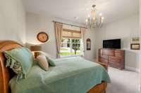 Guest bedroom offers great natural lighting, fresh paint, and chandelier.