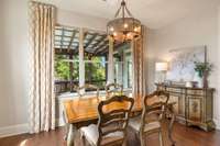 This dining space offers great natural lighting, and a view of the screened patio, back yard and lake!