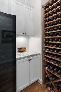 Wine frig/storage off the kitchen. Both items convey.