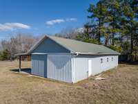 This spacious barn with attached shed, provides ample space for stables, feed/tack storage, and equipment.