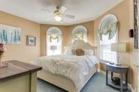 The office or bedroom downstairs has three arched windows that gives it a spacious and airy feel.