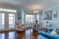 The French doors leading to the screened-in porch allow plenty of natural light to filter into the space.