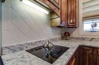 Beautiful tile back-splash over the cooktop.