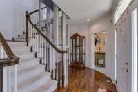 Gleaming hardwood floors & recessed lighting in the foyer. (There is an elevator next to the stairs, which can be removed if needed.)