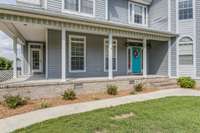 The wrap-around porch, with two entry doors, also provides a cozy and scenic spot for enjoying outdoor views.