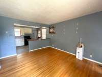 Open Family Room and kitchen with divider bar and "real" hardwood floors.