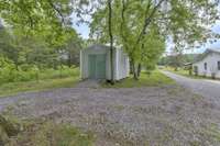 Additional storage shed on the side of the home provided.