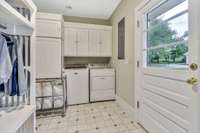 Generous laundry space/mudroom off of the back of the home with an abundance of storage.