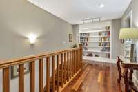 Upstairs with custom built-in shelving and abundant lighting.