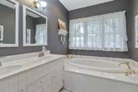 Double vanities and large soaker tub in Primary bathroom suite.