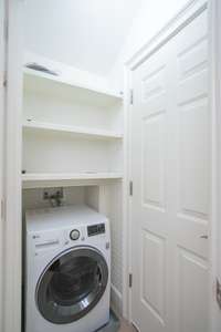 Washer/Dryer combo unit on level 3 of home for bedroom's 3 and 4 use. This level could be used as an in-law suite as it has two bedrooms, a full bathroom, an elevator reaching that floor and a washer dryer unit.