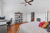 Primary bedroom on second floor with hardwood flooring. Vaulted ceiling and natural light galore.