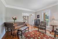 Another view of the living room looking into the front foyer. Beautiful hardwoods throughout most of home.