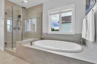 Soaking tub with tile surround.