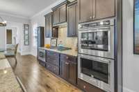 Kitchenaid double ovens and staggered height cabinets are highlights of the open design kitchen.