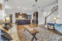 View of living area showing the staircase to 2nd level. Coat closet in the entry foyer across from the staircase.