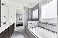 Deep soaking tub with frosted glass window for privacy but plenty of light.