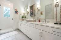 Dual vanity sink & walk in shower with subway tile.