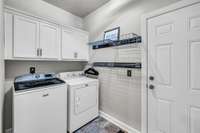 Laundry room on main level with cabinetry