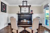 Breakfast nook with fireplace & paneled walls